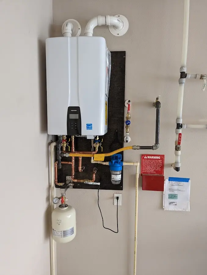 Professional plumber installing copper piping in a Millbury home